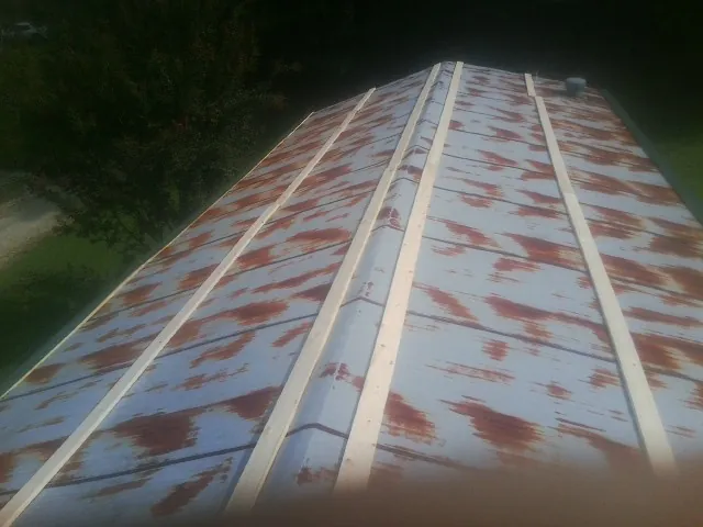 Rusted metal roof panels with new wood purlins before replacement — Storm Damage Roof Repair in Beach Haven by Roofing Brothers