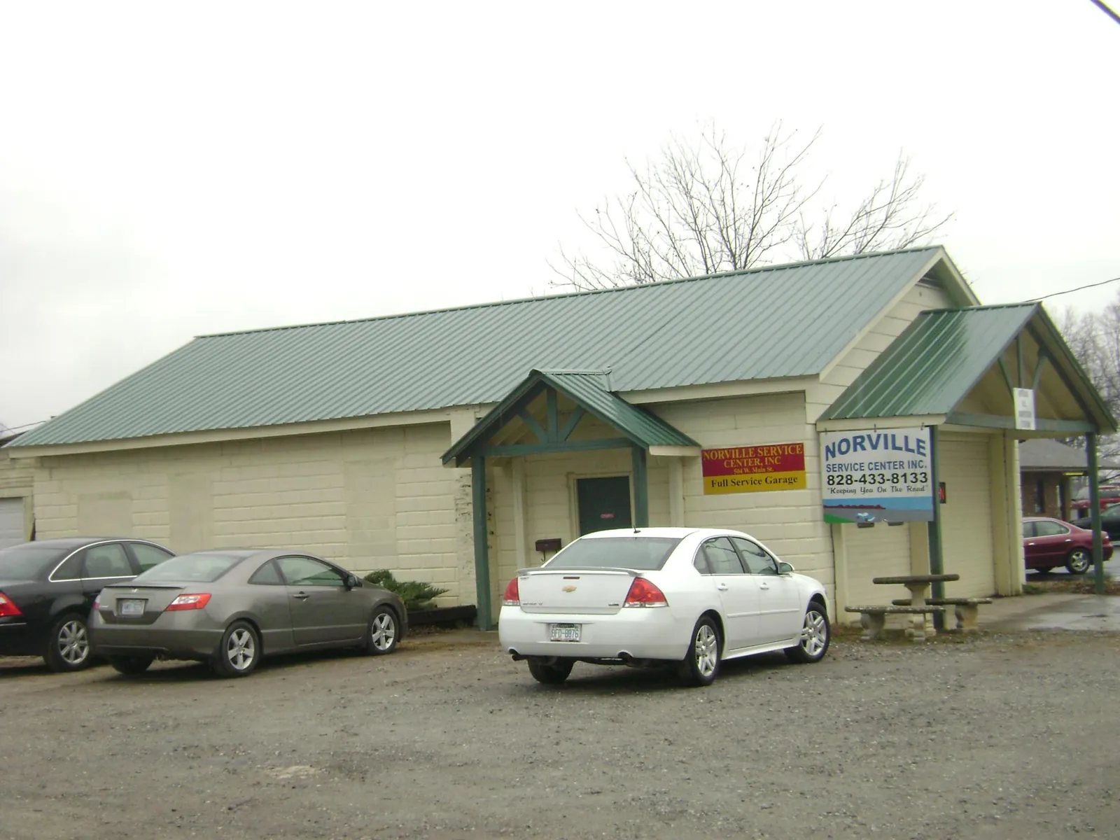 Green metal roof on a service garage with a covered entry in Beach Haven